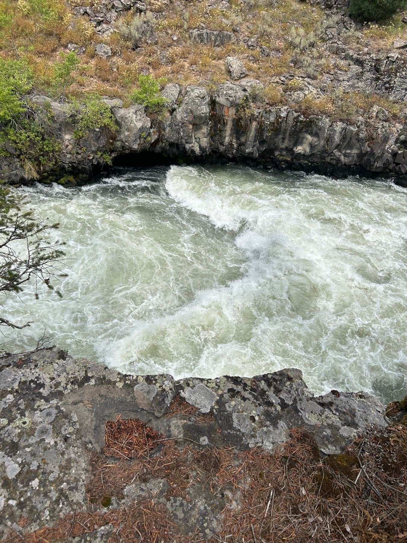 Overhead view of whitewater surging through a rock chute