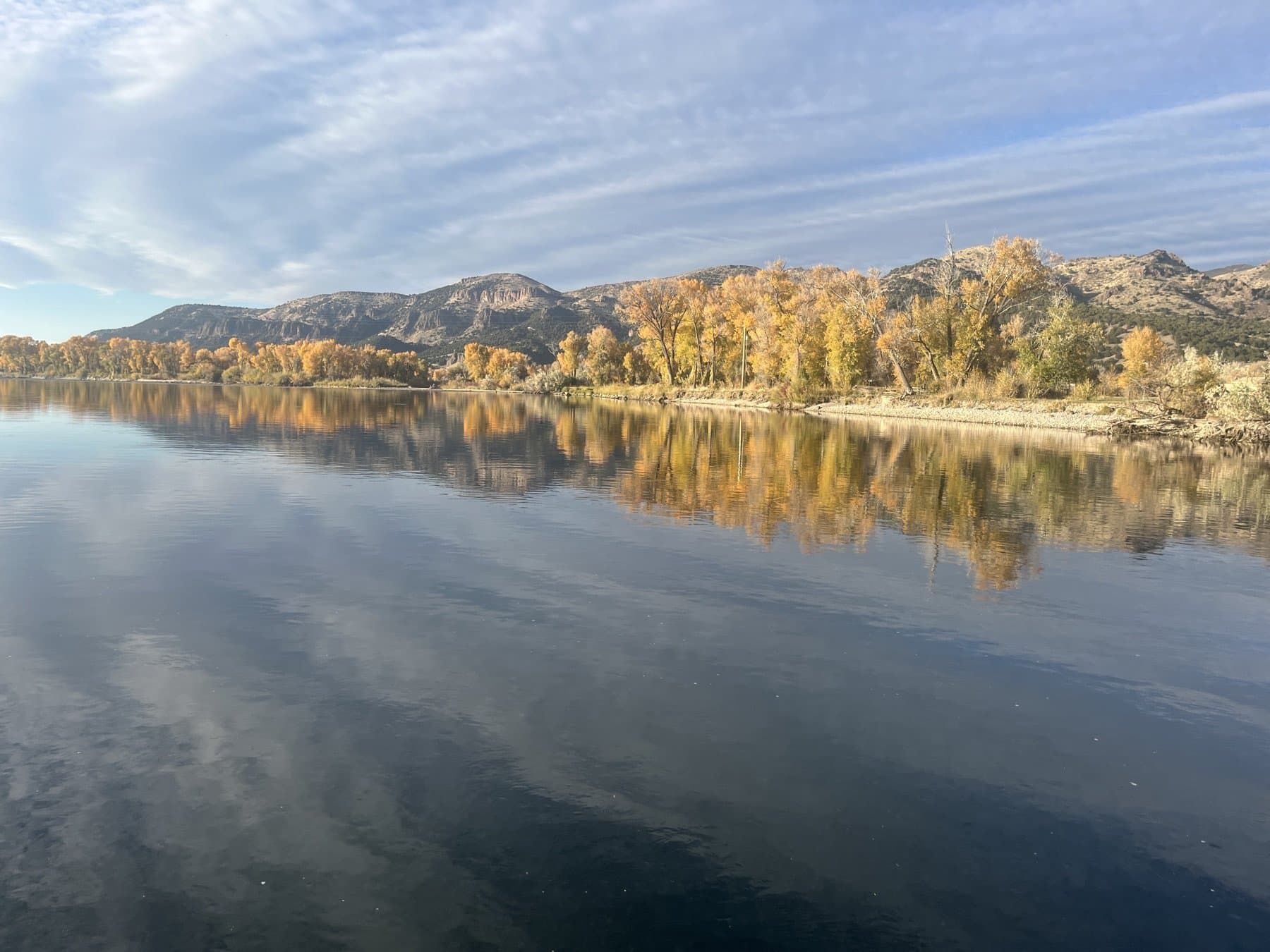 Fall foliage reflecting on the calm South Fork water