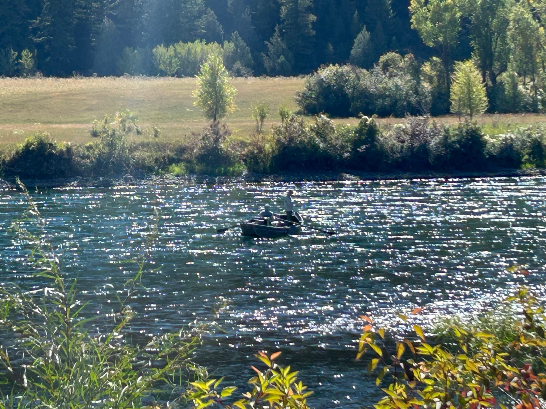 Drift boat floating the South Fork on a sunlit afternoon
